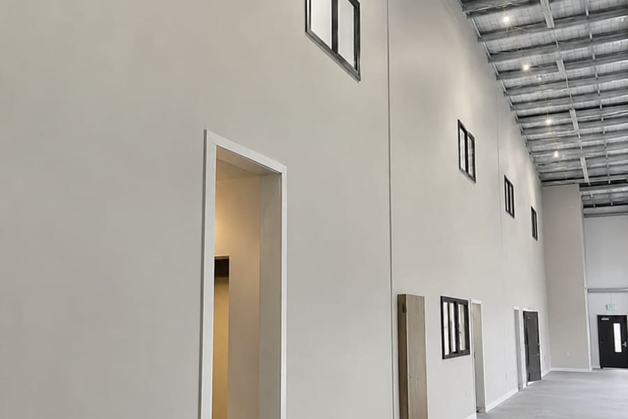 The same interior after plastering, with smooth, evenly finished paint-ready walls