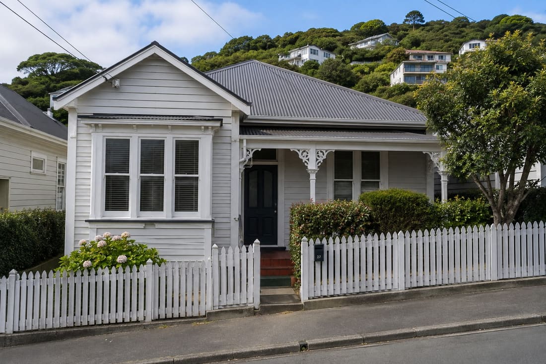 Restored Wellington character villa with white weatherboards and a picket fence
