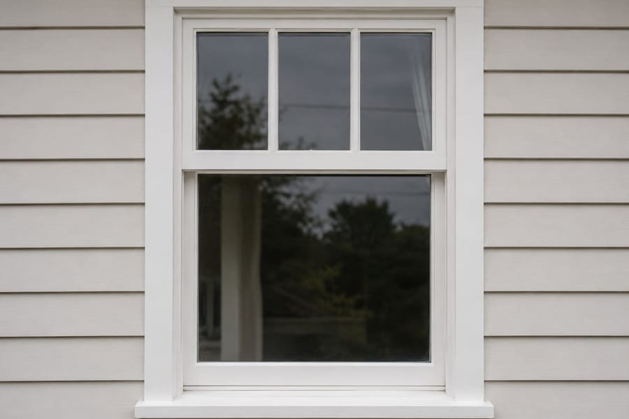 The same window after repair, with a sound frame and fresh white paintwork